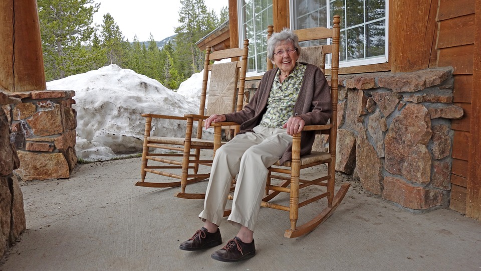 Elderly woman in a porch rocking chair
